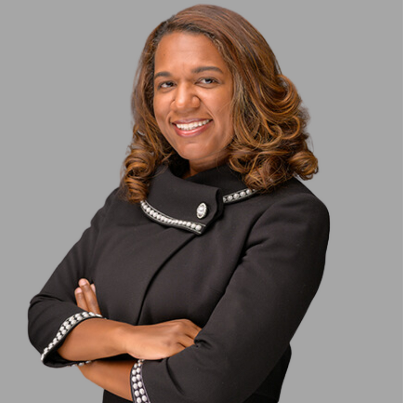 Courtney Phillips headshot. She is in a black top with her arms crossed.