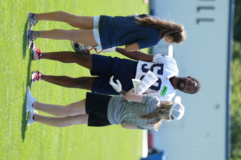 woman talks with football player