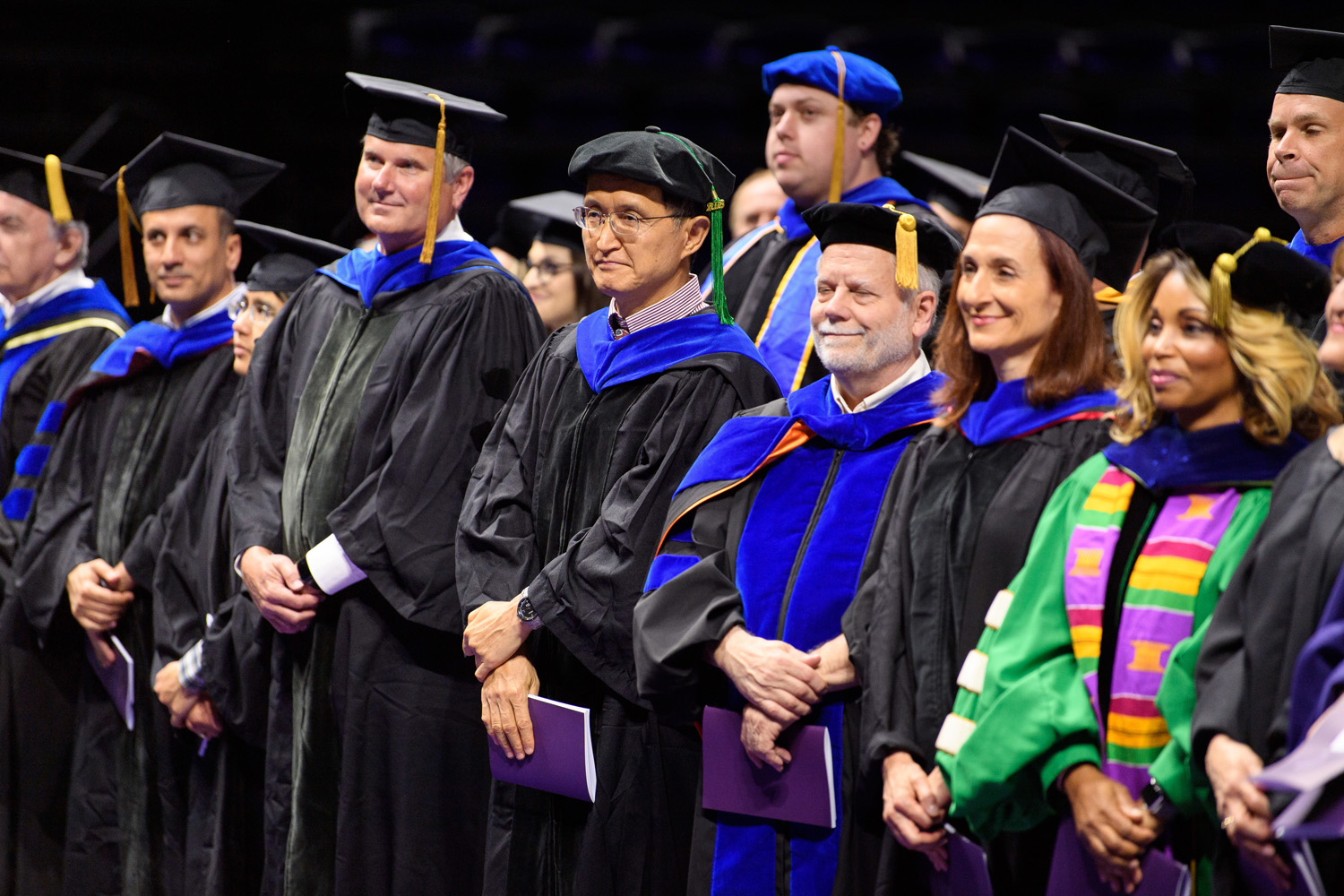 Faculty members in graduation caps and gowns. 