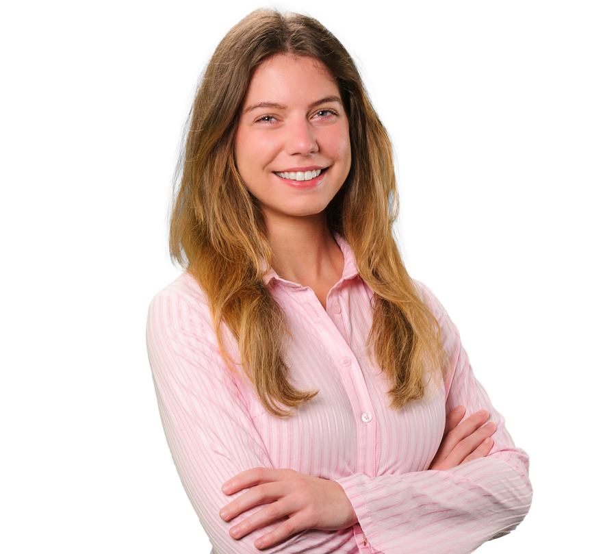 Karly Robledo in a pink shirt with her arms crossed.