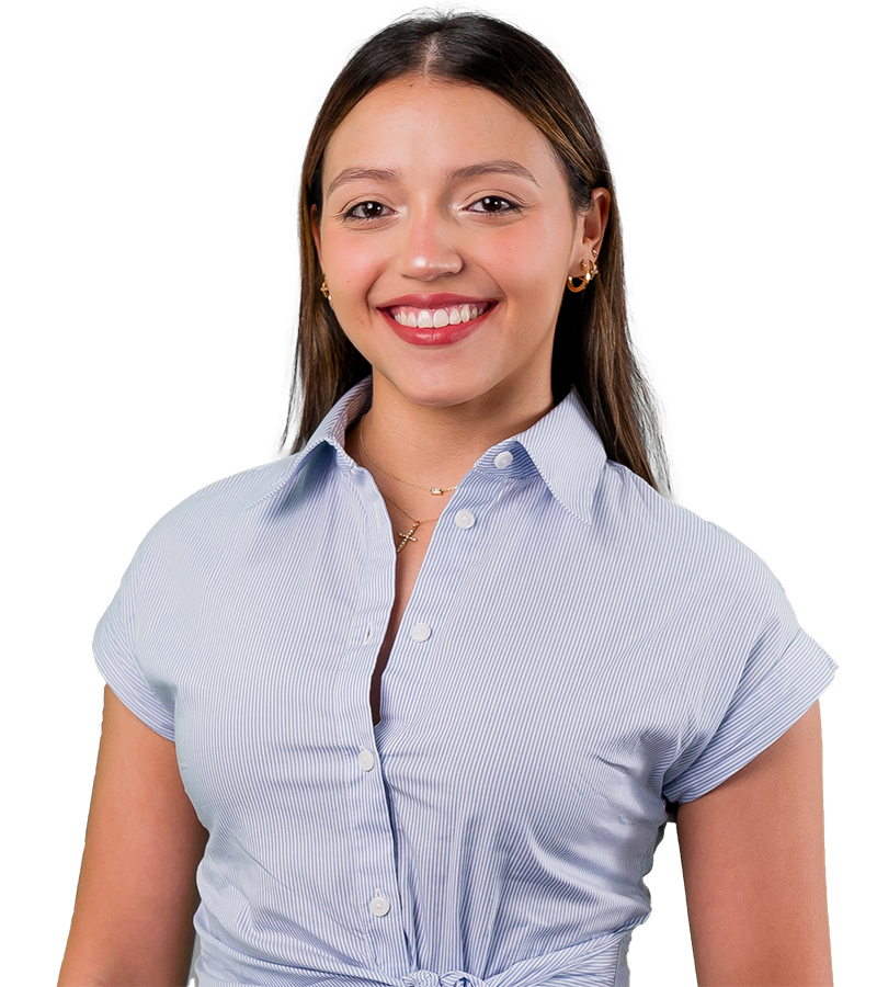 Maria Anzola wears a blue and white wrap blouse in this headshot on a white background.