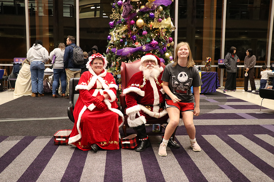 girl with Santa and Mrs. Claus