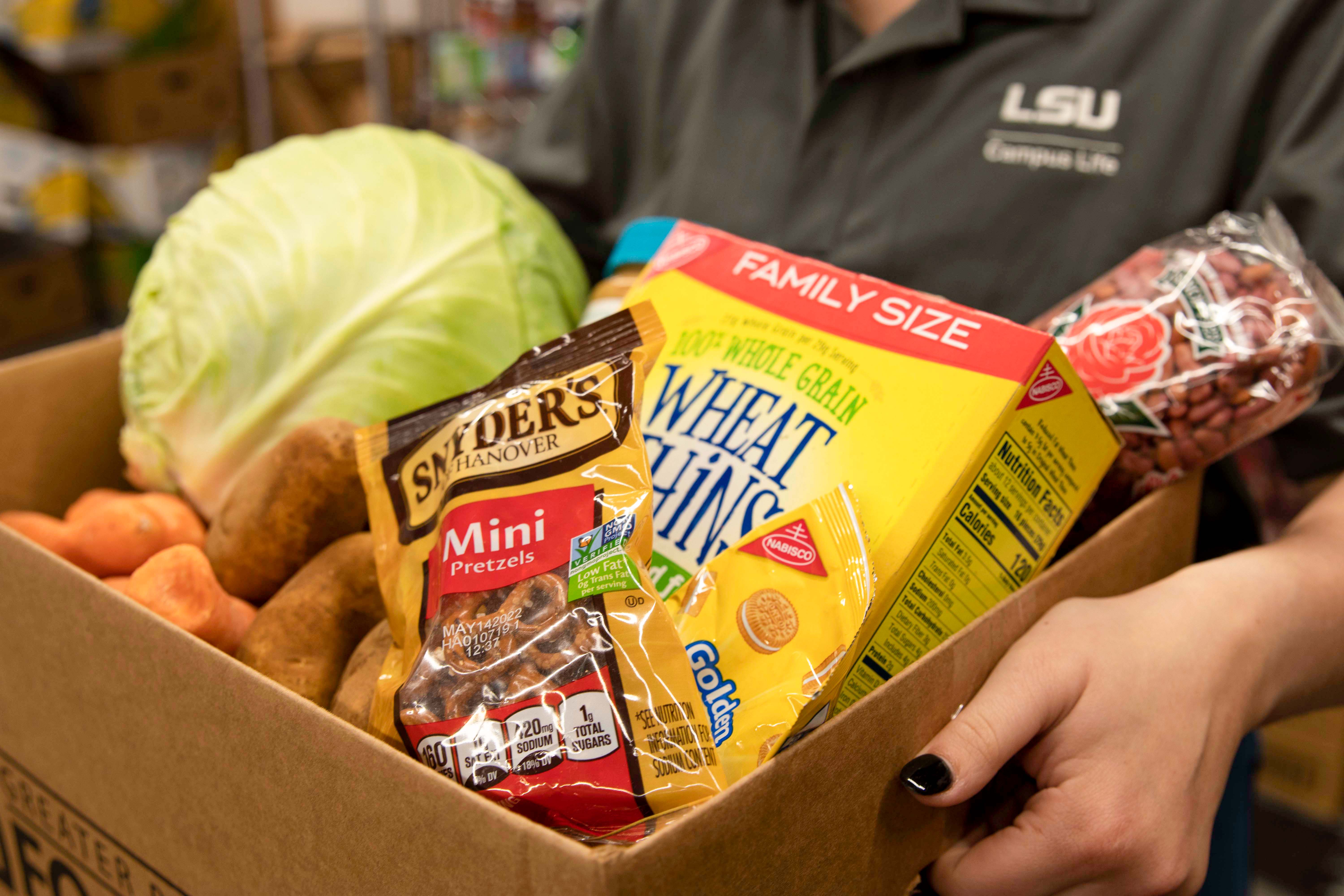 box of pantry and produce items